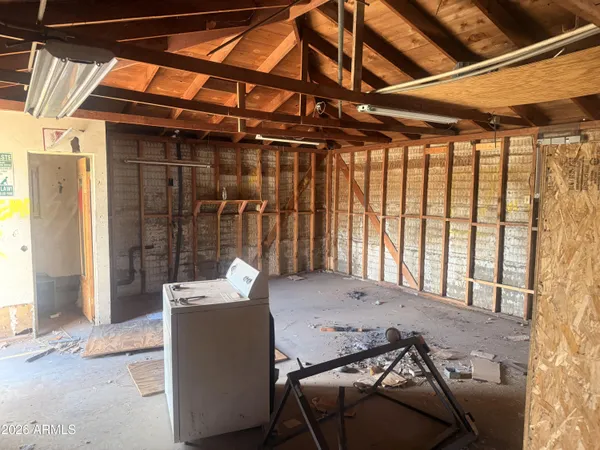 a spacious bedroom with a bed and a cabinets