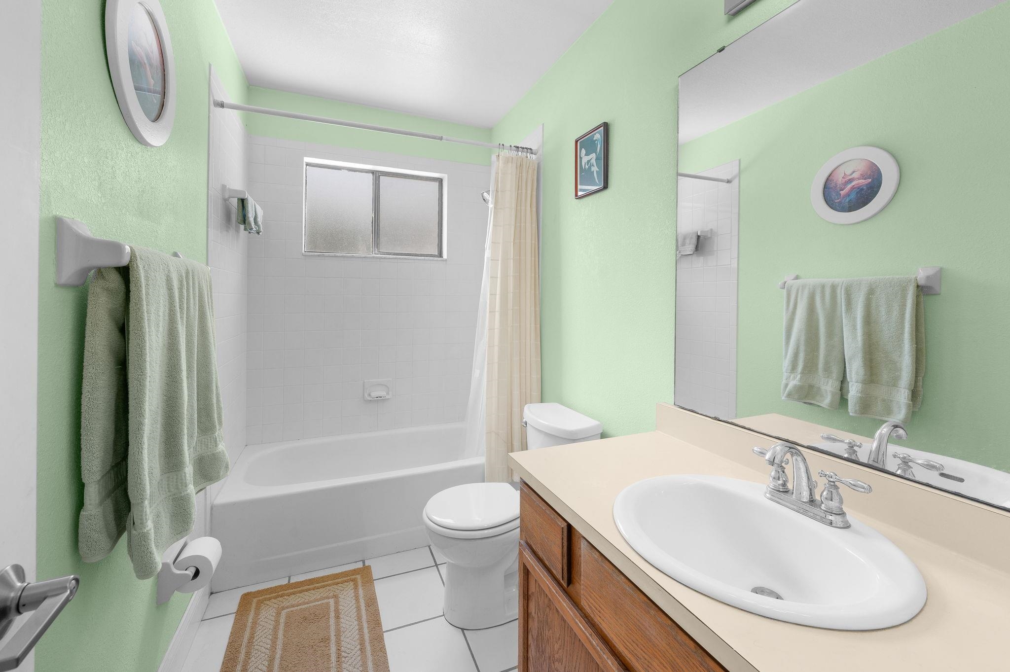 1126 Prince Road St. Augustine, FL 32086 - Photo 20 of 42 a bathroom with a sink a toilet and a mirror