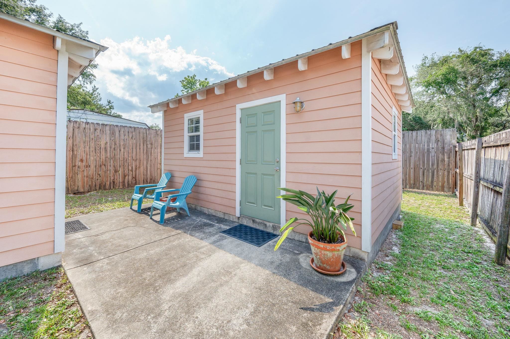 1126 Prince Road St. Augustine, FL 32086 - Photo 3 of 42 a view of a backyard with chair and potted plants