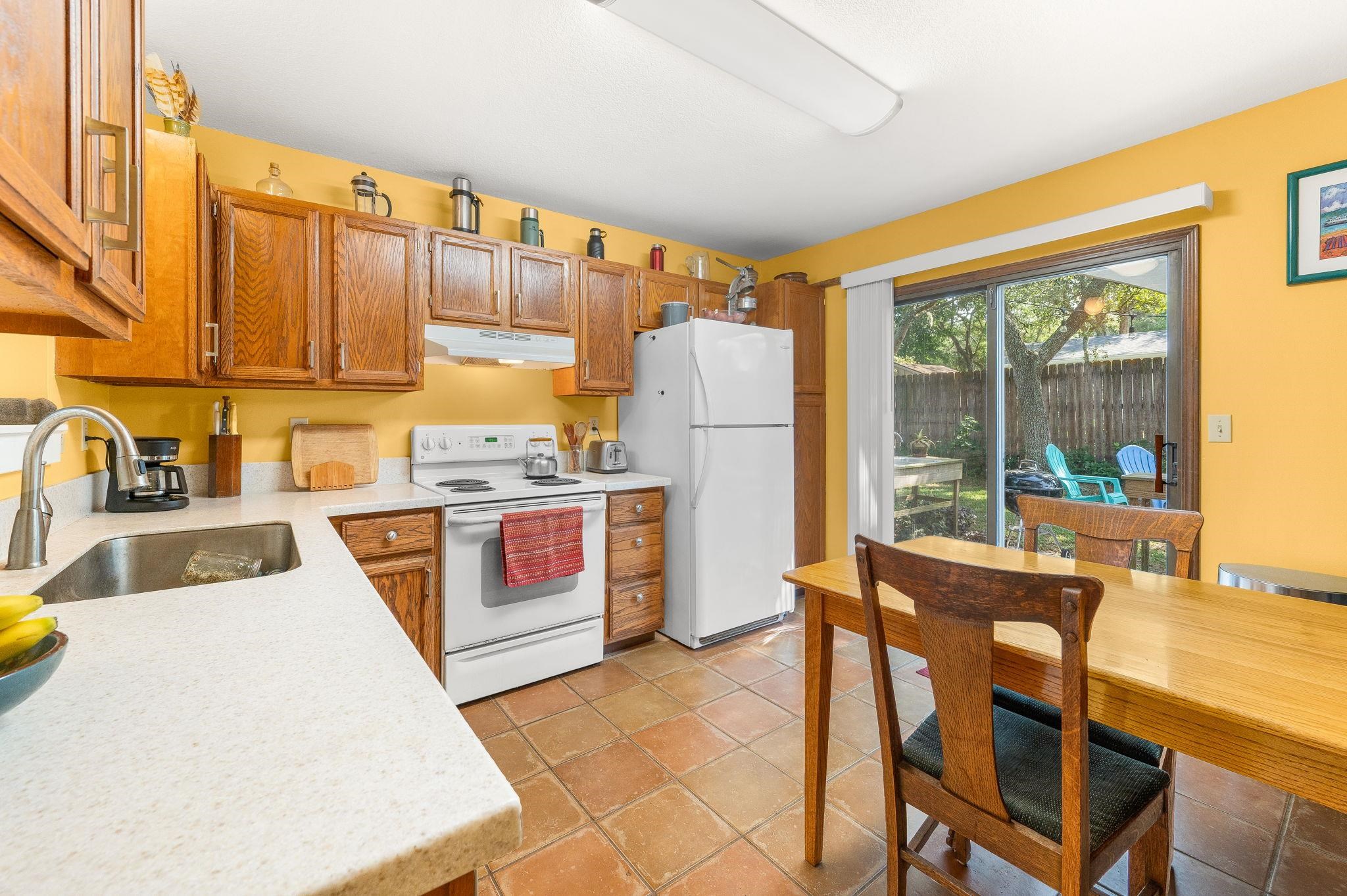 1126 Prince Road St. Augustine, FL 32086 - Photo 9 of 42 a kitchen with a stove a refrigerator and a dining table