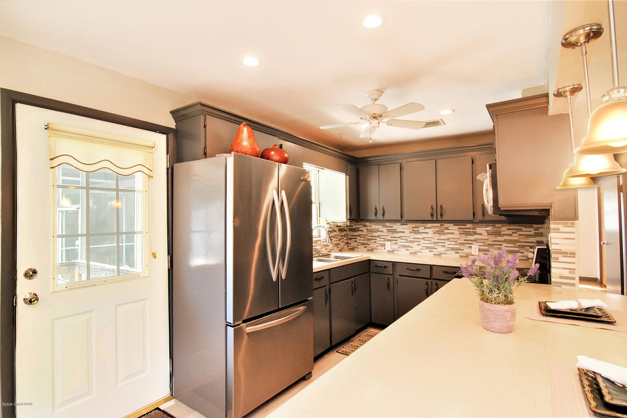 1053 Bernice Road Rockledge, FL 32955 - Photo 17 of 30 a kitchen with stainless steel appliances granite countertop a refrigerator and a sink