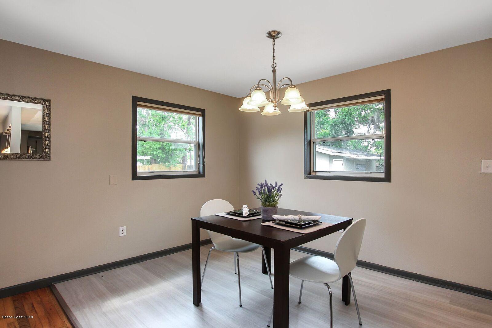 1053 Bernice Road Rockledge, FL 32955 - Photo 18 of 30 a view of a dining room with furniture and chandelier