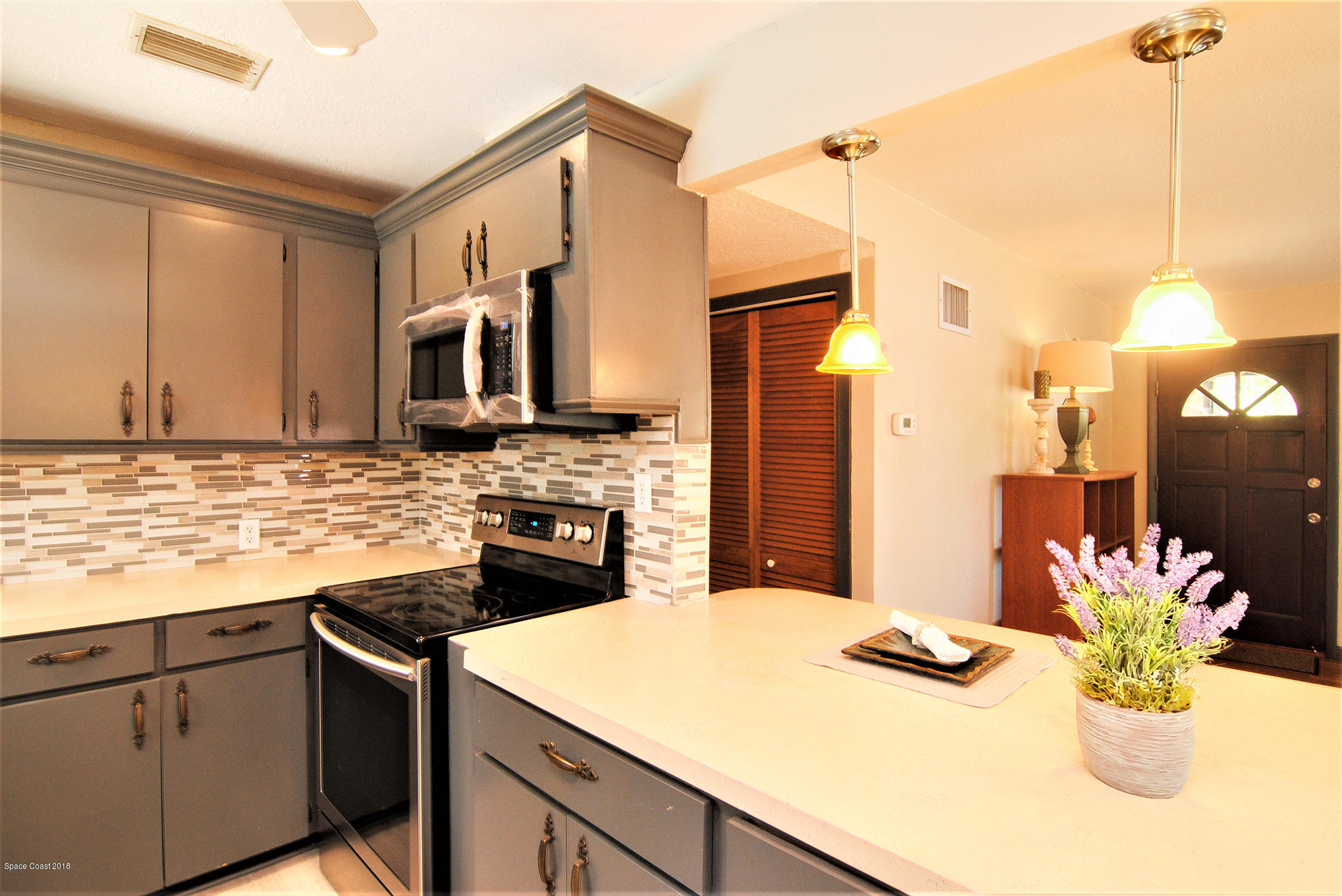 1053 Bernice Road Rockledge, FL 32955 - Photo 19 of 30 a kitchen with a sink appliances and cabinets