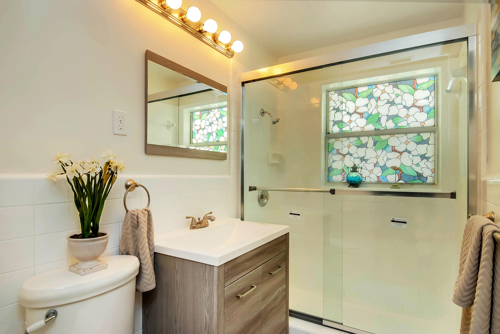 1053 Bernice Road Rockledge, FL 32955 - Photo 22 of 30 a bathroom with a sink and a mirror