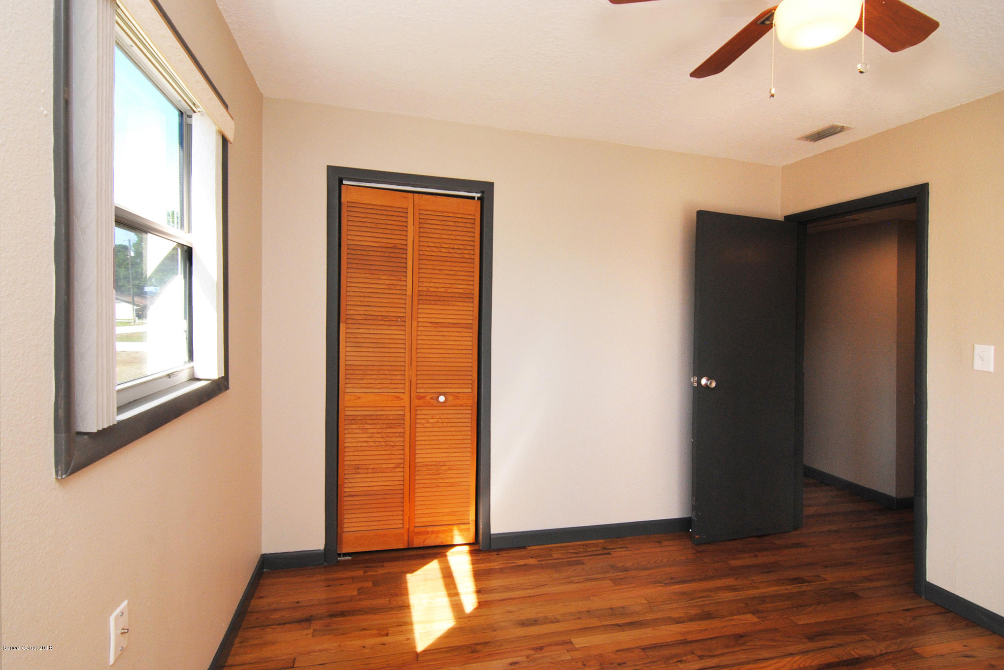 1053 Bernice Road Rockledge, FL 32955 - Photo 24 of 30 a view of an empty room with wooden floor
