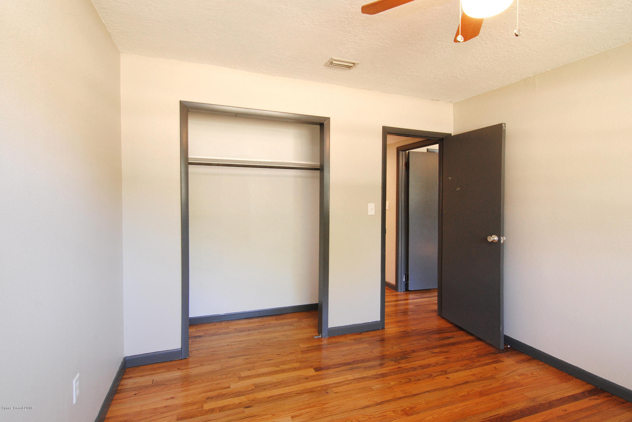 1053 Bernice Road Rockledge, FL 32955 - Photo 28 of 30 a view of an empty room with wooden floor and a window
