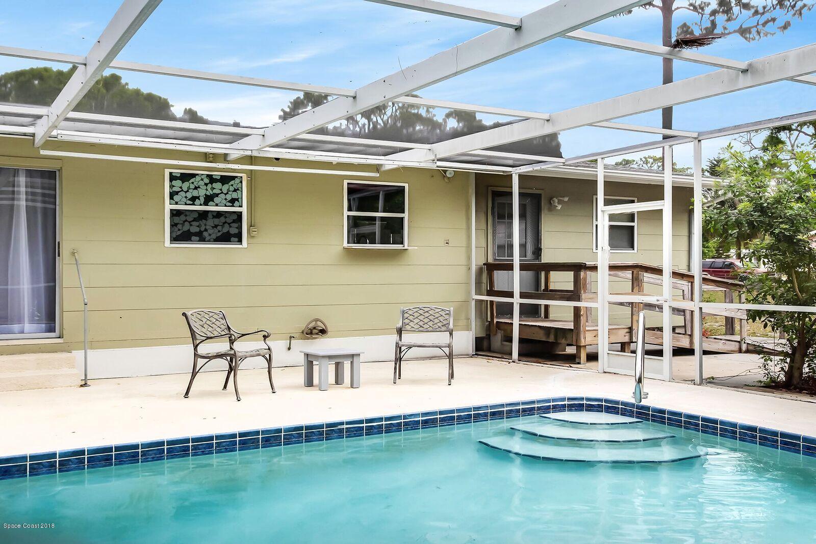 1053 Bernice Road Rockledge, FL 32955 - Photo 30 of 30 a swimming pool with outdoor seating and yard