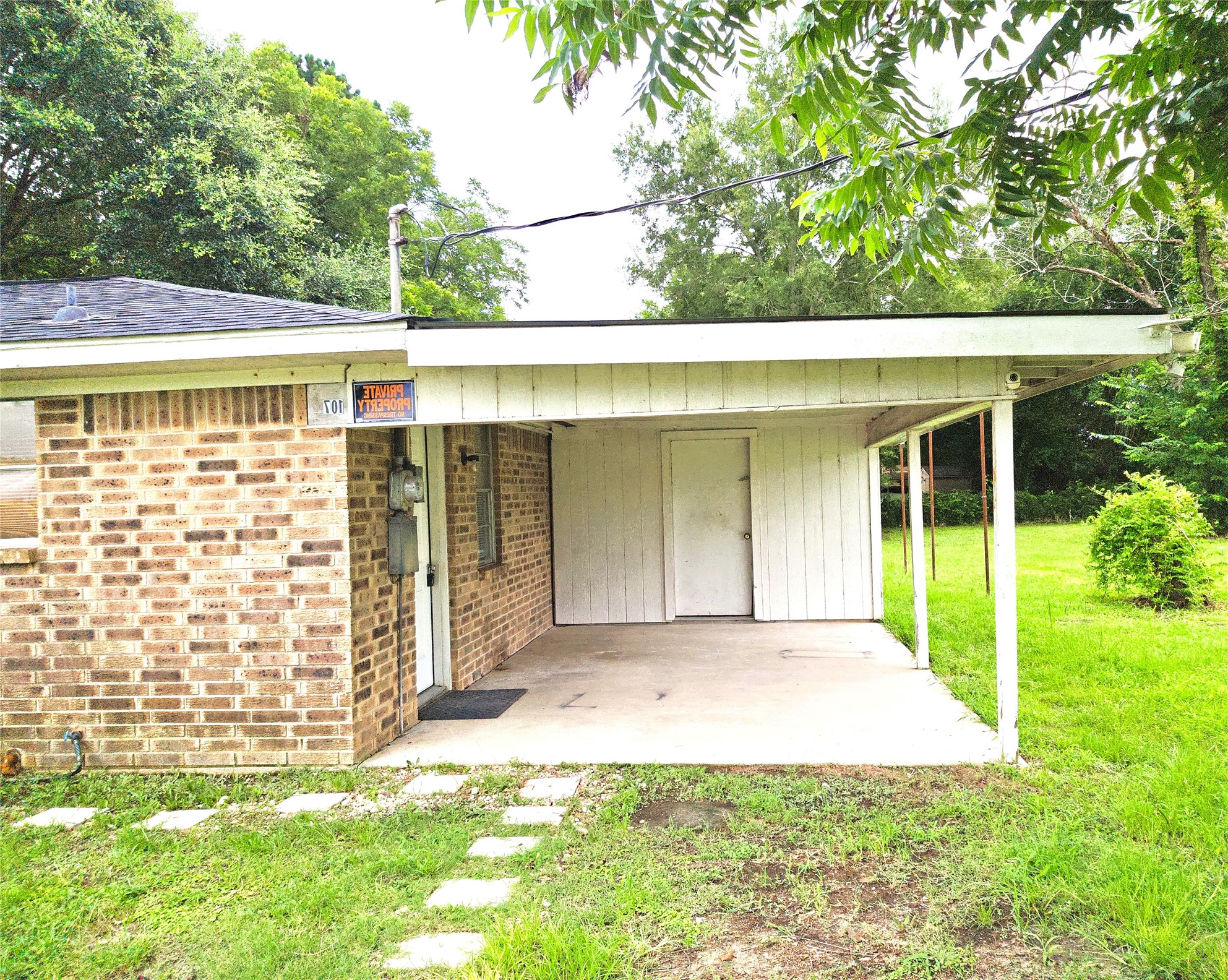 107 Cypress Street Trinity, TX 75862 - Photo 2 of 8 Washer and dryer laundry room is under carport.