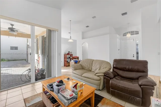 a living room with furniture a rug and a chandelier