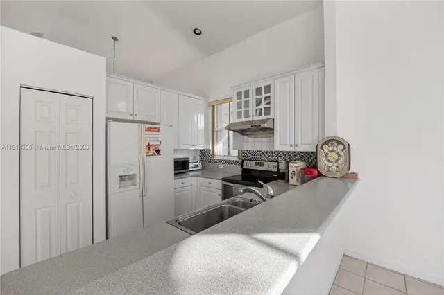 a living room with furniture a clock and a window