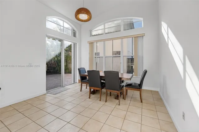 a view of a dining room with furniture and a large window
