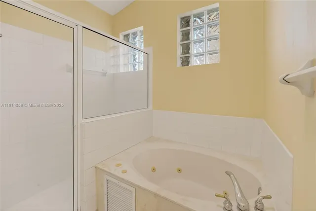 a bathroom with a shower sink and mirror
