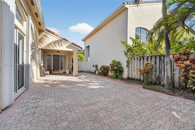 a view of a house with a yard and large tree