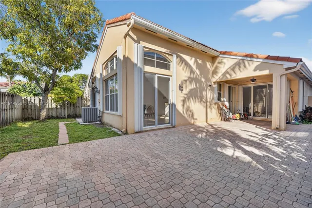 a front view of a house with a flower garden