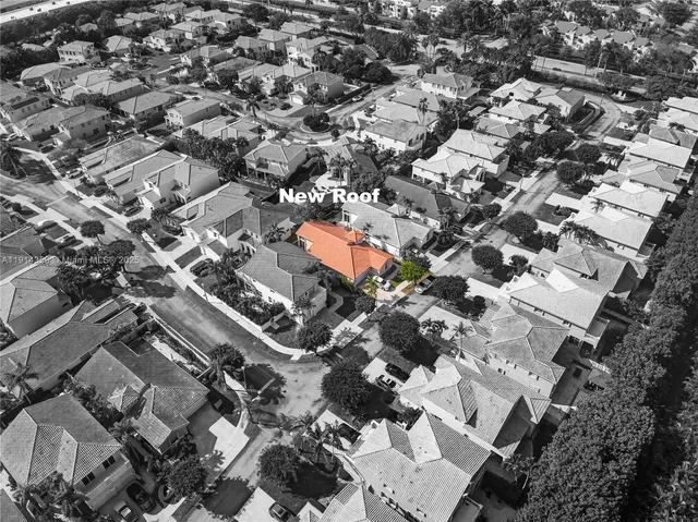 an aerial view of residential houses with outdoor space