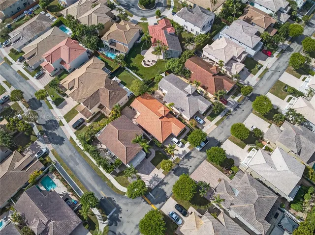 an aerial view of residential houses with outdoor space