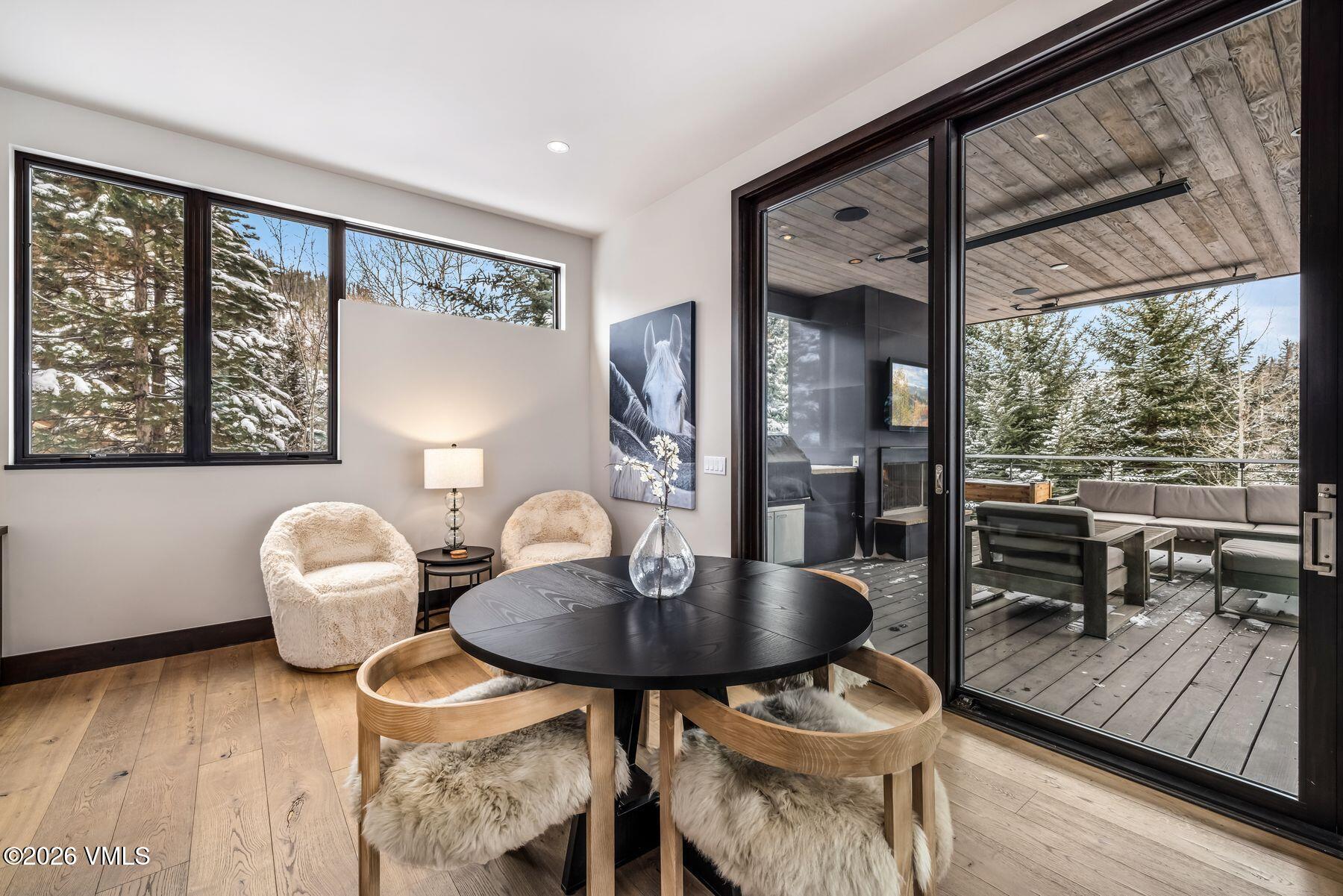2440 Chamonix Lane Vail, CO 81657 - Photo 11 of 36 a dining room with furniture and wooden floor