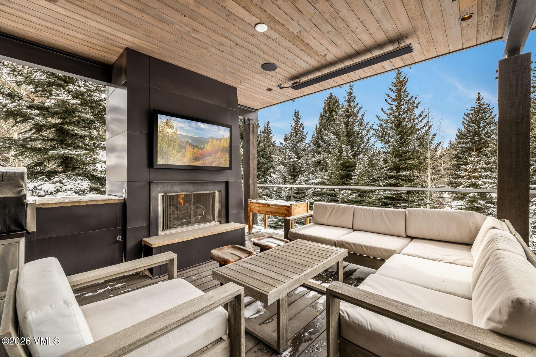 2440 Chamonix Lane Vail, CO 81657 - Photo 12 of 36 a balcony with furniture and a fireplace