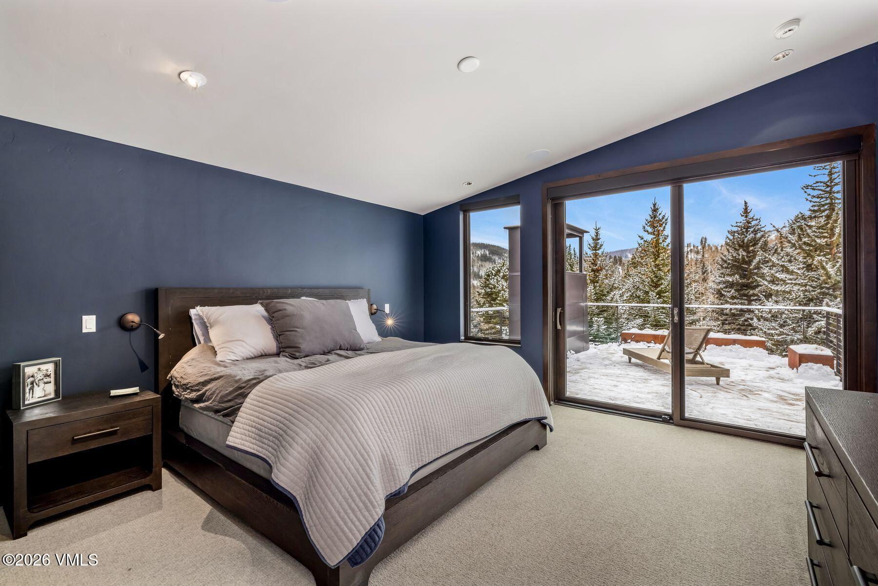 2440 Chamonix Lane Vail, CO 81657 - Photo 16 of 36 a bedroom with a large bed and a large window