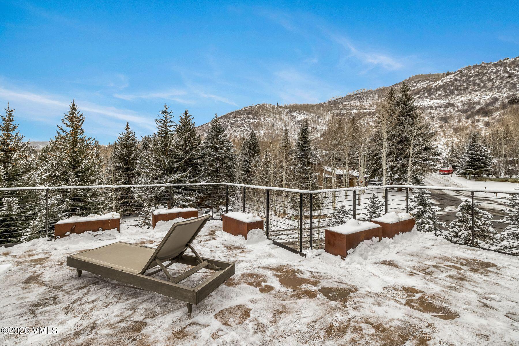 2440 Chamonix Lane Vail, CO 81657 - Photo 20 of 36 a view of a terrace with a bench