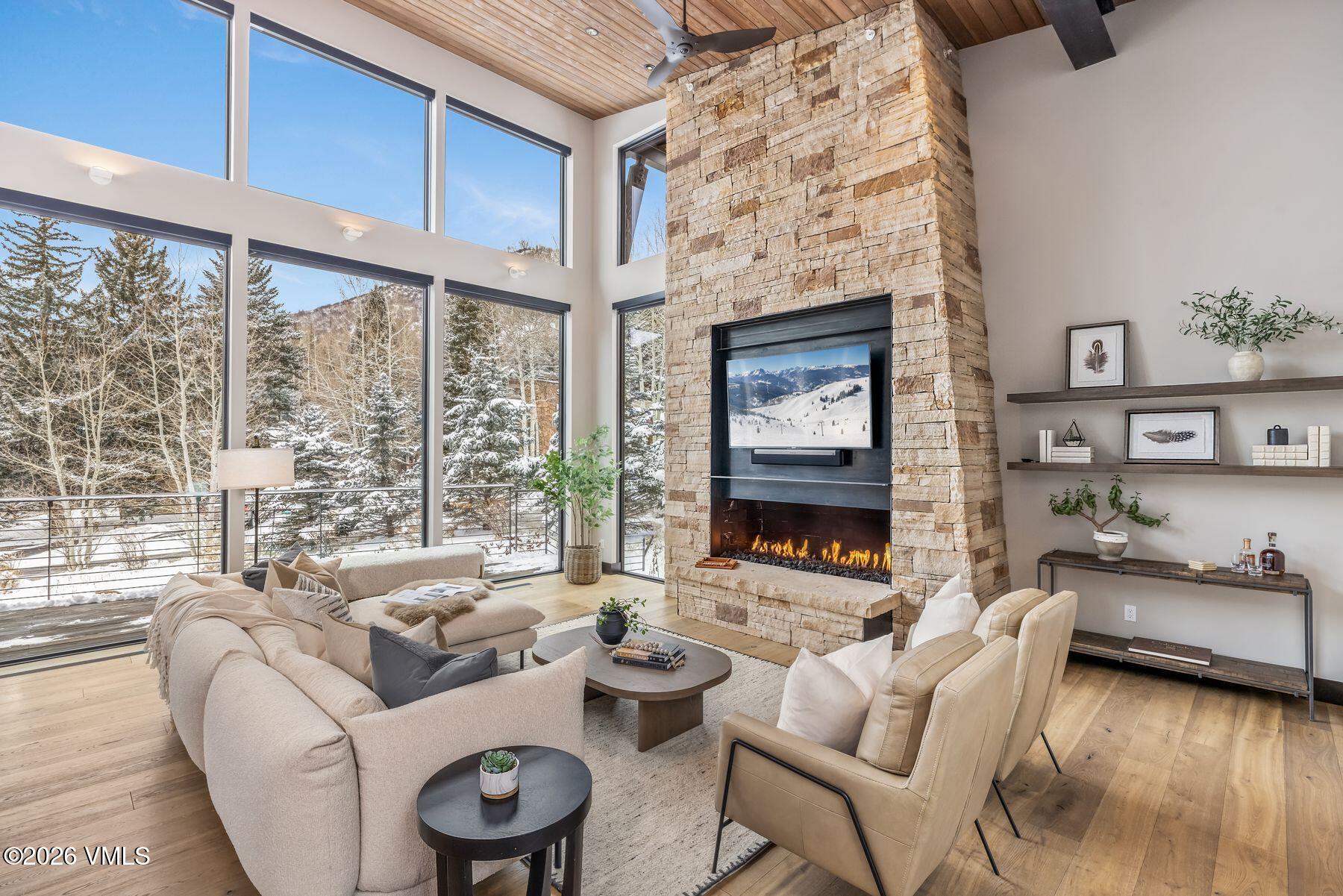 2440 Chamonix Lane Vail, CO 81657 - Photo 2 of 36 a living room with furniture and a floor to ceiling window