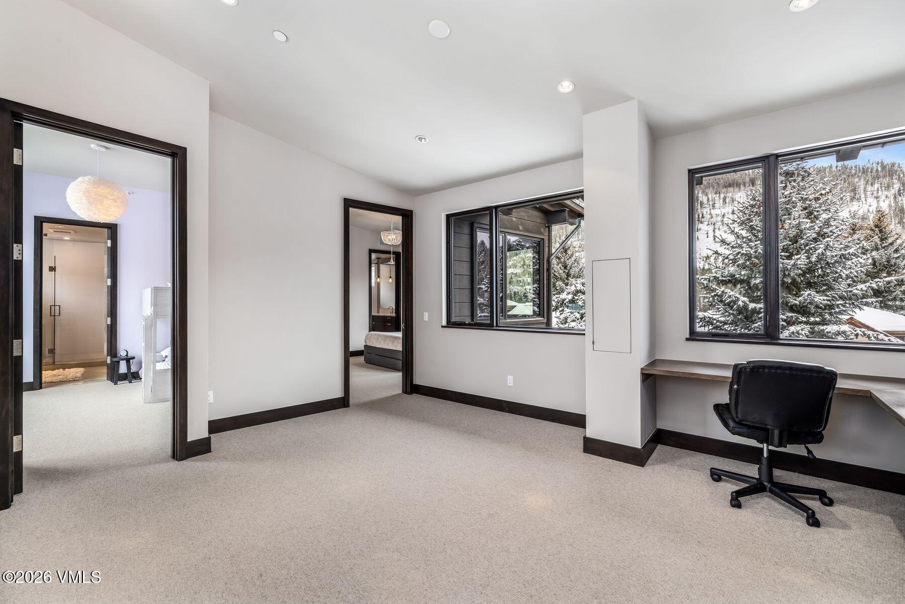 2440 Chamonix Lane Vail, CO 81657 - Photo 21 of 36 a view of an empty room with a window and a bathroom
