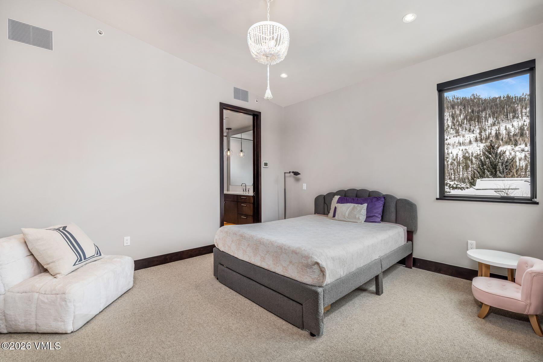 2440 Chamonix Lane Vail, CO 81657 - Photo 22 of 36 a bedroom with a bed and a couch