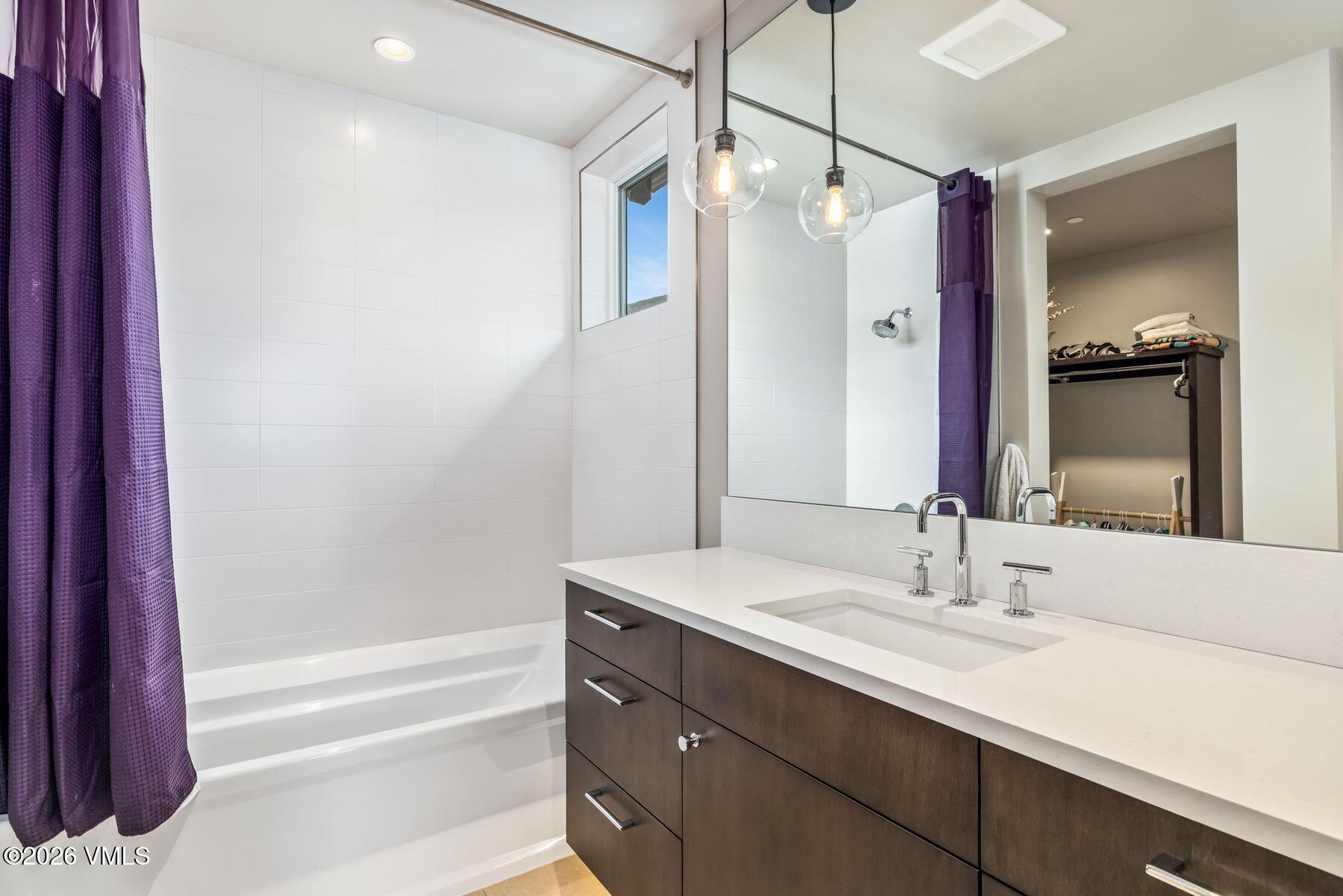 2440 Chamonix Lane Vail, CO 81657 - Photo 24 of 36 a bathroom with a double vanity sink mirror and shower