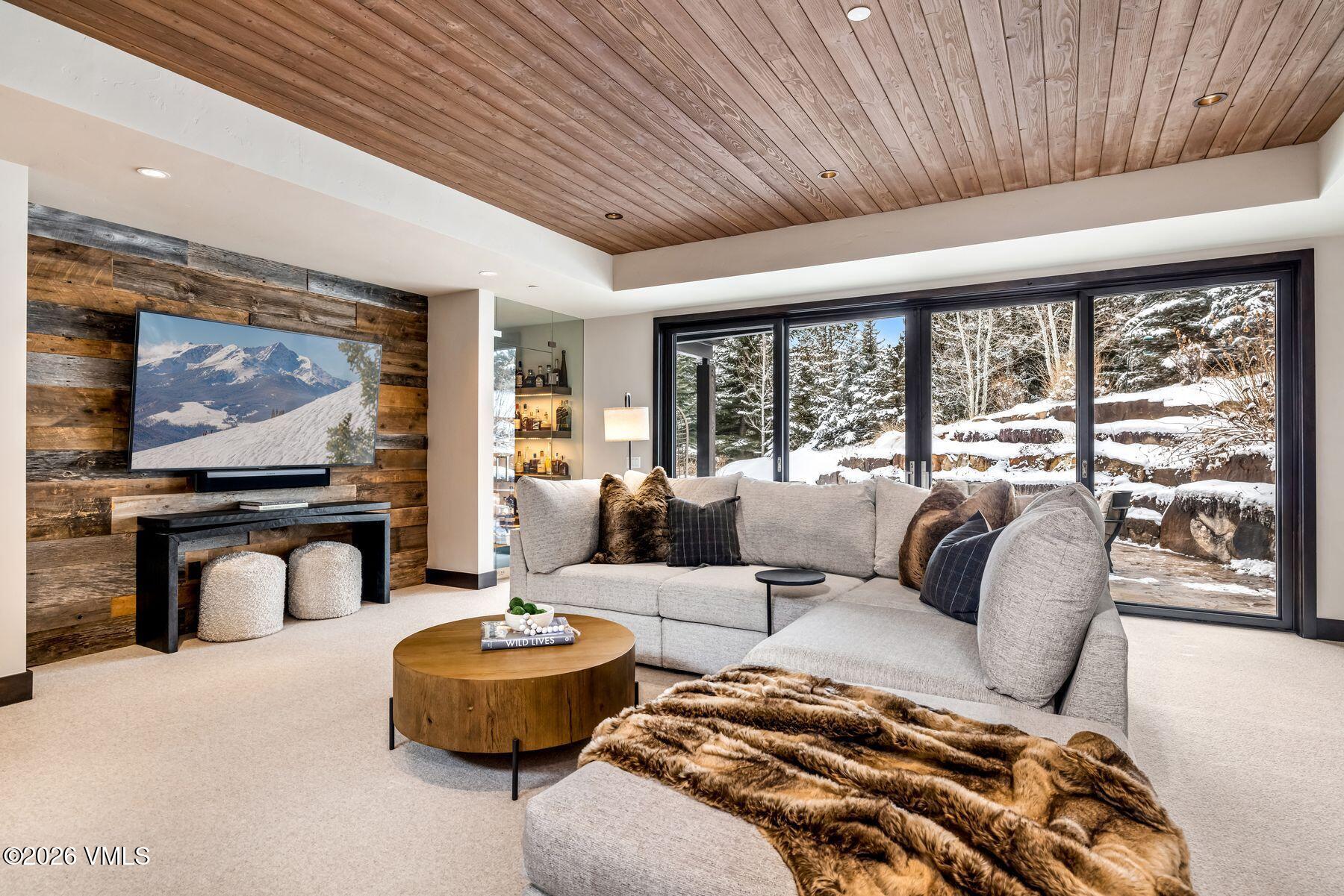 2440 Chamonix Lane Vail, CO 81657 - Photo 28 of 36 a living room with furniture and a flat screen tv