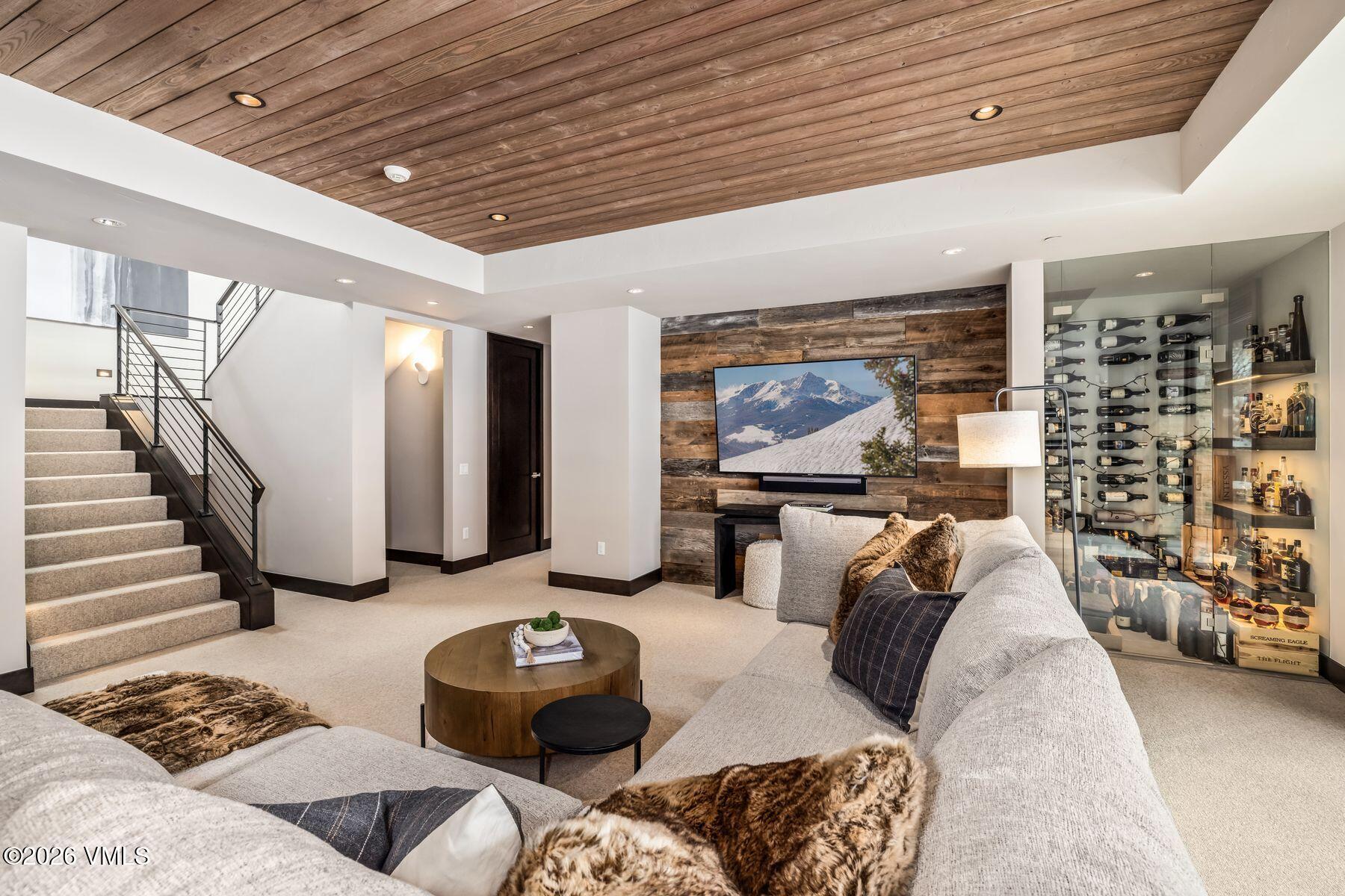 2440 Chamonix Lane Vail, CO 81657 - Photo 29 of 36 a living room with furniture and a flat screen tv