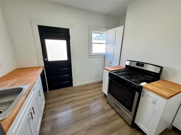 a kitchen with wooden floors and a stove