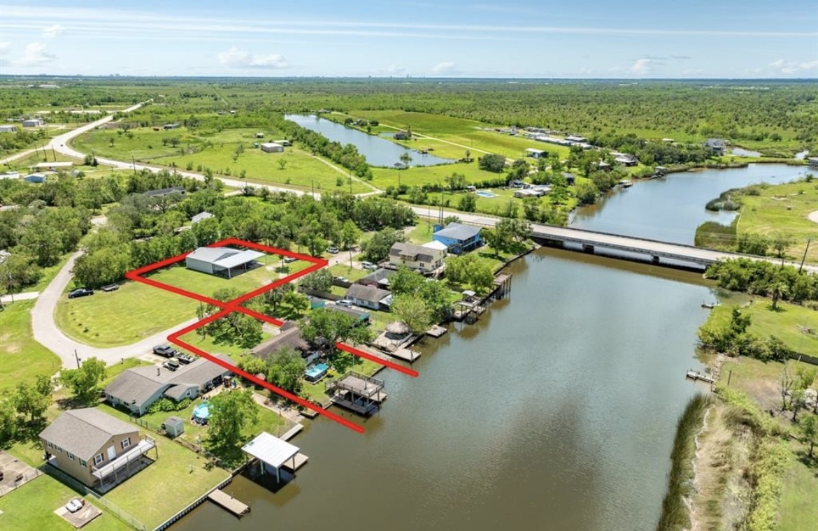 an aerial view of residential houses with outdoor space and swimming pool