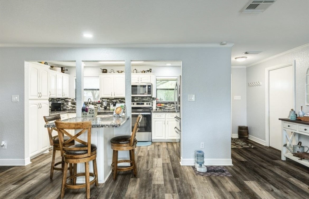 131 Bastrop Bayou Drive Angleton, TX 77515 - Photo 11 of 36 a kitchen with a table and chairs in it