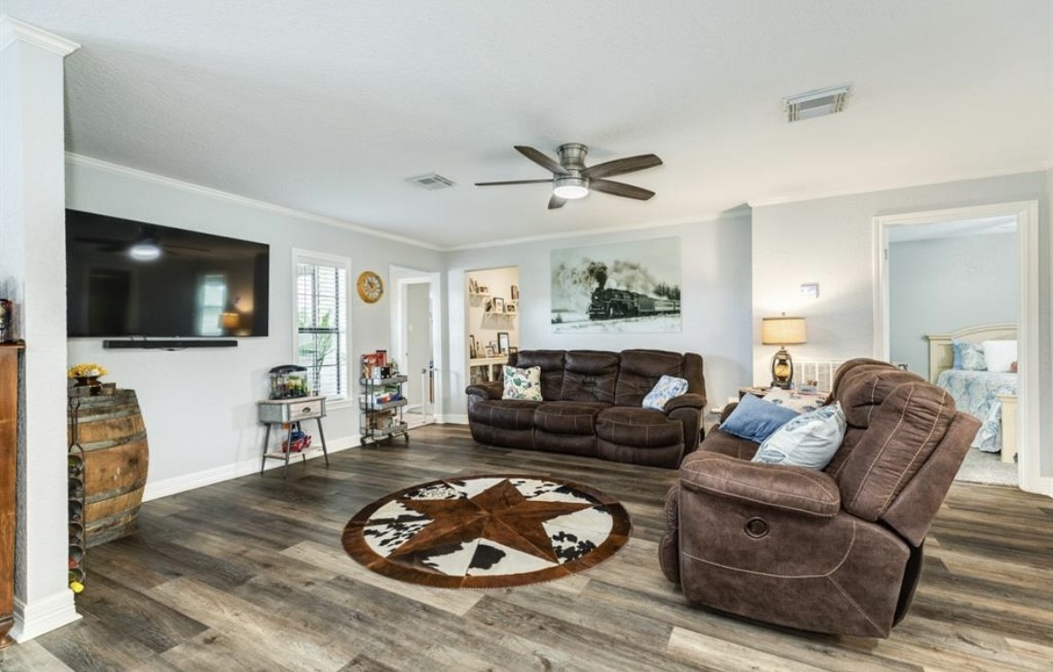 131 Bastrop Bayou Drive Angleton, TX 77515 - Photo 14 of 36 a living room with furniture a flat screen tv and a fireplace