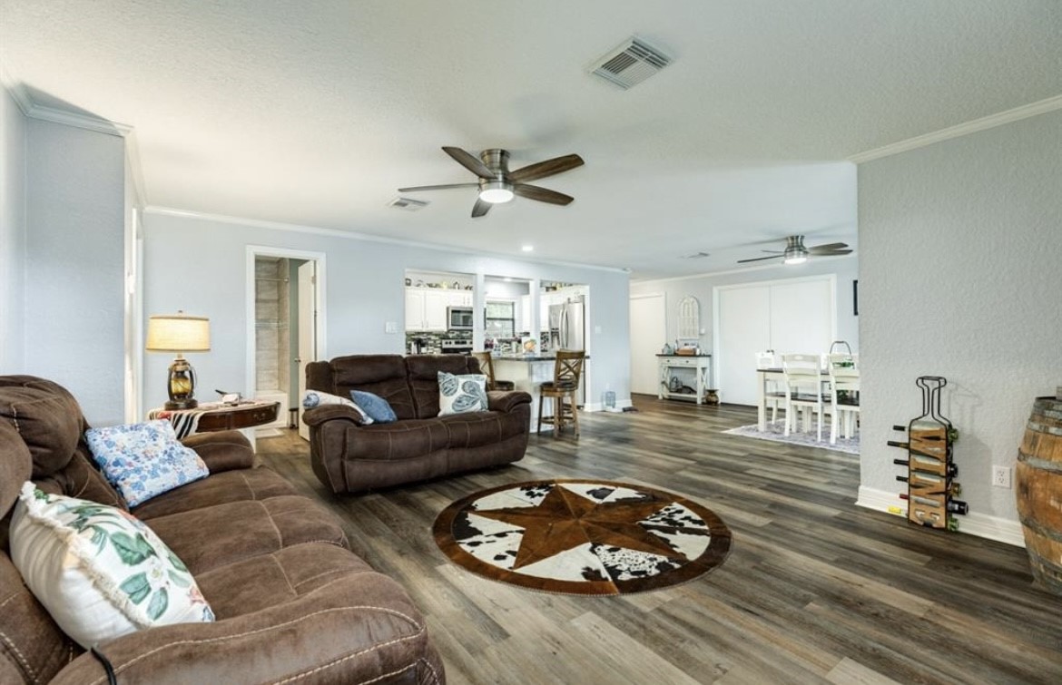 131 Bastrop Bayou Drive Angleton, TX 77515 - Photo 15 of 36 a living room with furniture floor to ceiling window and a wooden floor