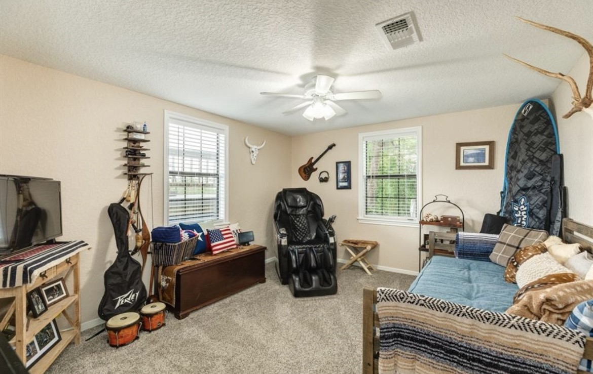 131 Bastrop Bayou Drive Angleton, TX 77515 - Photo 20 of 36 a living room with furniture gym equipment and a flat screen tv