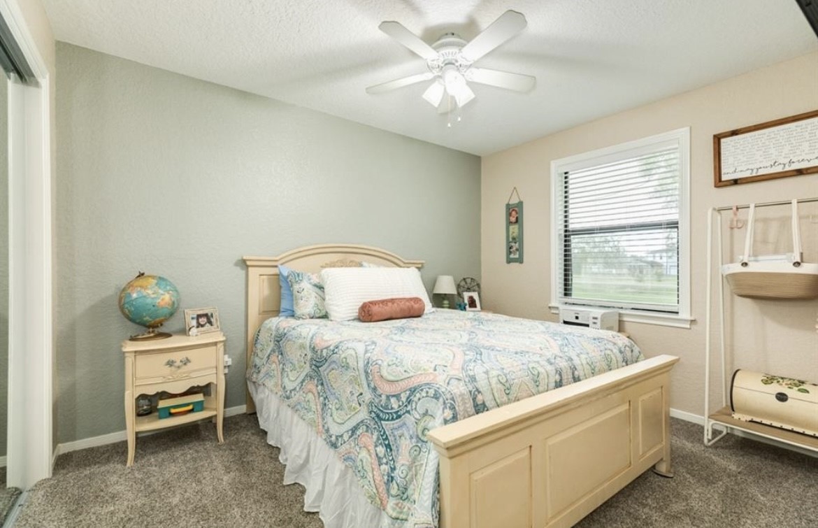 131 Bastrop Bayou Drive Angleton, TX 77515 - Photo 21 of 36 a bedroom with a bed and a window