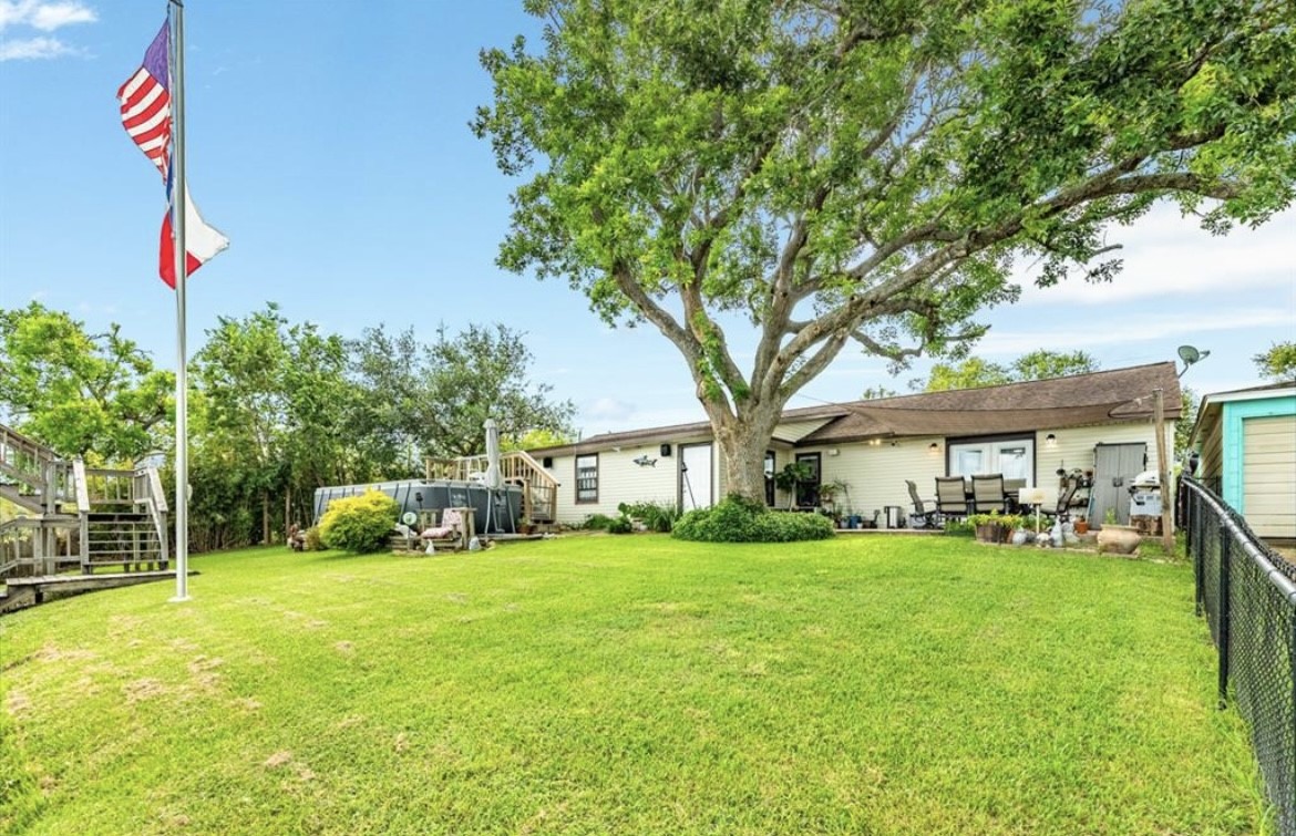 131 Bastrop Bayou Drive Angleton, TX 77515 - Photo 26 of 36 a front view of a house with a yard and trees