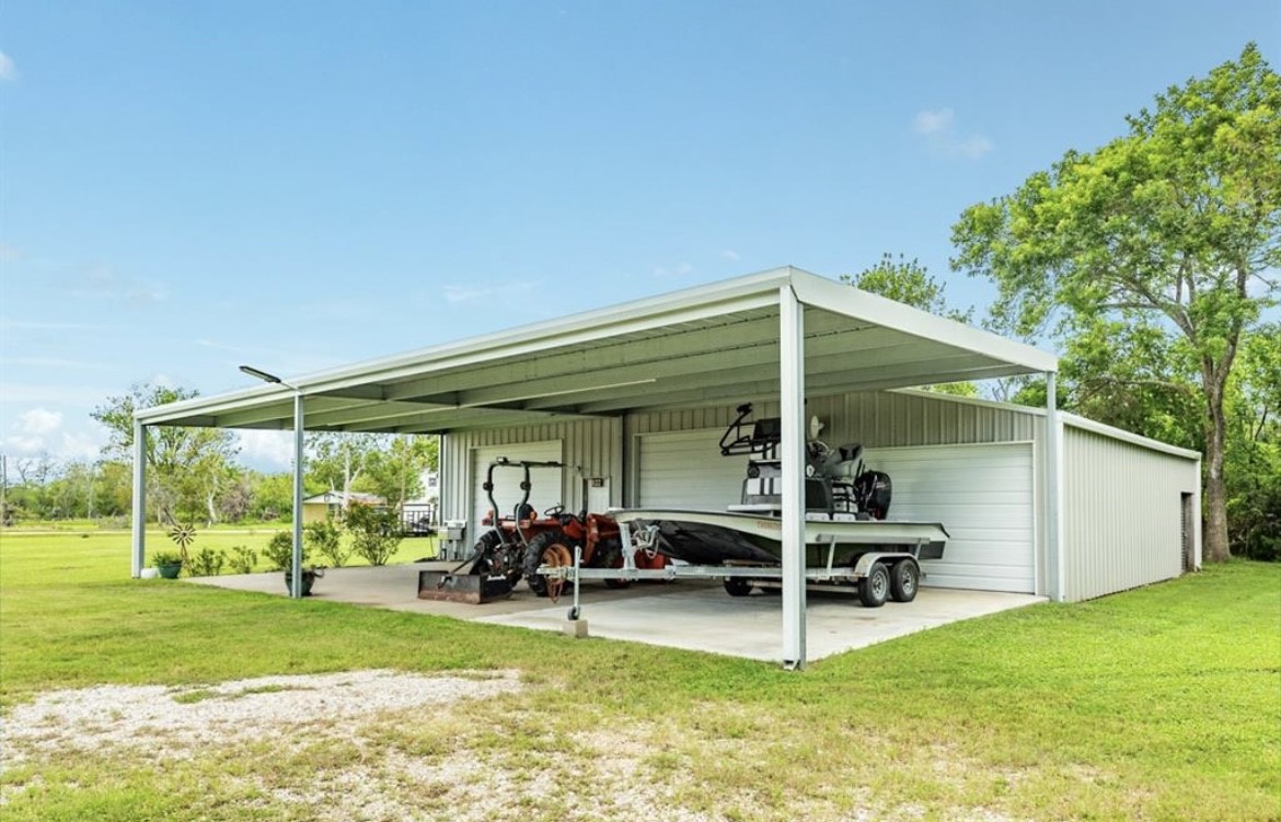 131 Bastrop Bayou Drive Angleton, TX 77515 - Photo 30 of 36 a view of a patio with table and chairs under an umbrella