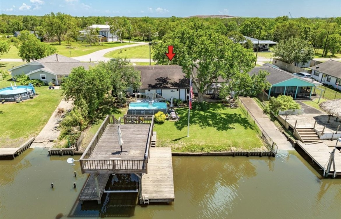 131 Bastrop Bayou Drive Angleton, TX 77515 - Photo 4 of 36 a view of a lake with a house