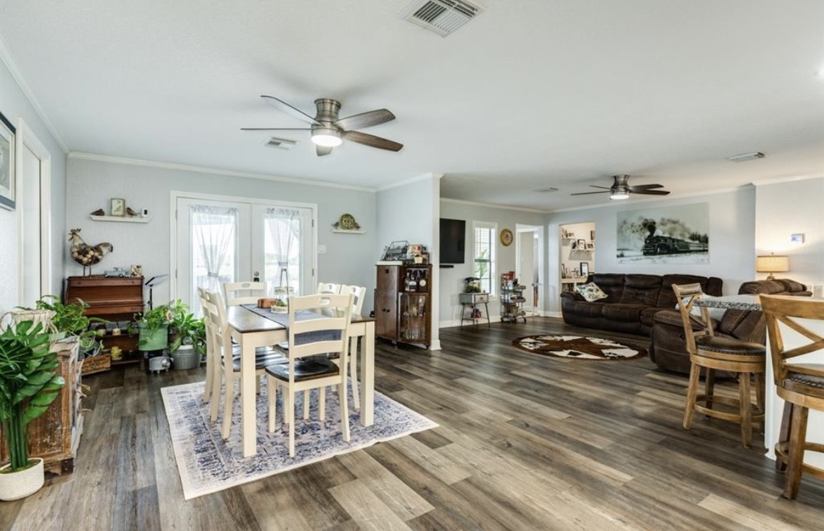 131 Bastrop Bayou Drive Angleton, TX 77515 - Photo 9 of 36 a view of a dining room with furniture window and wooden floor