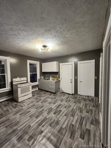 a view of a livingroom with furniture and kitchen