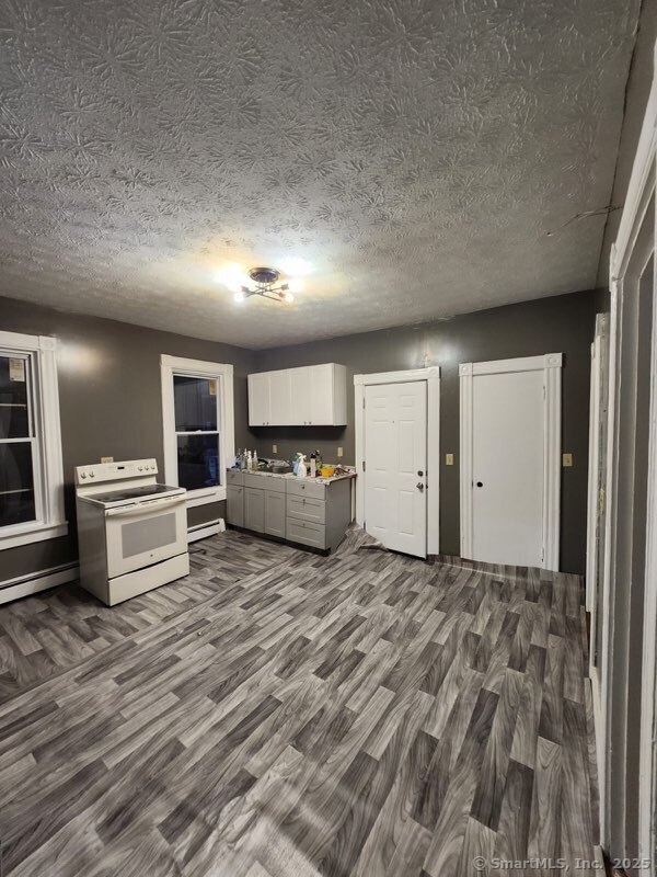 a view of a livingroom with furniture and kitchen