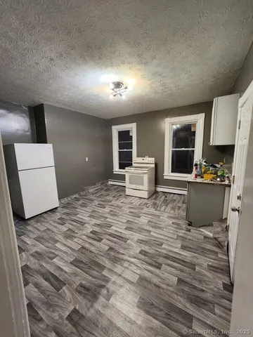 a room with a bed and a television