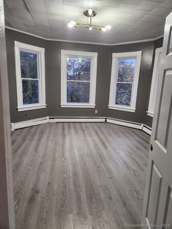 199 Jefferson Street Hartford, CT 06106 - Photo 5 of 9 a view of an empty room with wooden floor and window