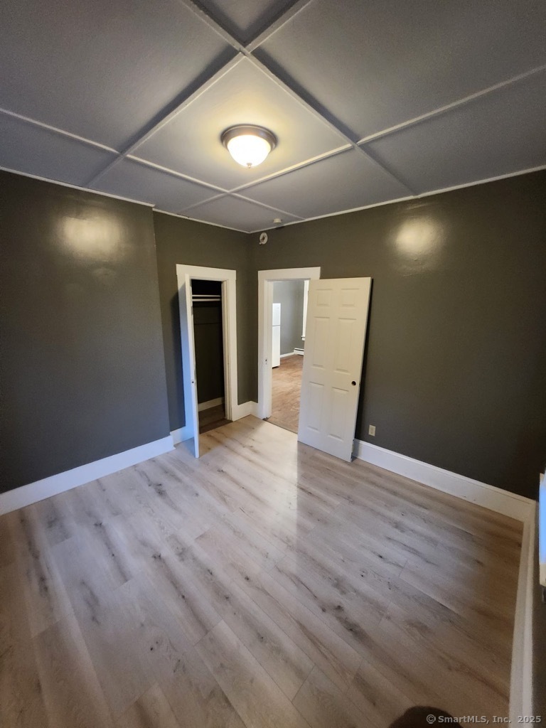 199 Jefferson Street Hartford, CT 06106 - Photo 9 of 9 an empty room with wooden floor and windows