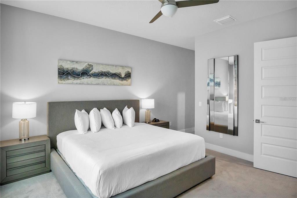7740 Sandy Ridge Drive, Unit 106 Reunion, FL 34747 - Photo 14 of 43 a bedroom with a bed and walk in closet