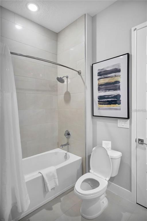 7740 Sandy Ridge Drive, Unit 106 Reunion, FL 34747 - Photo 22 of 43 a white toilet sitting next to a bath tub and a shower