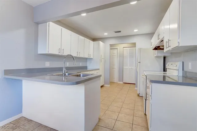 a kitchen with stainless steel appliances granite countertop a sink and cabinets
