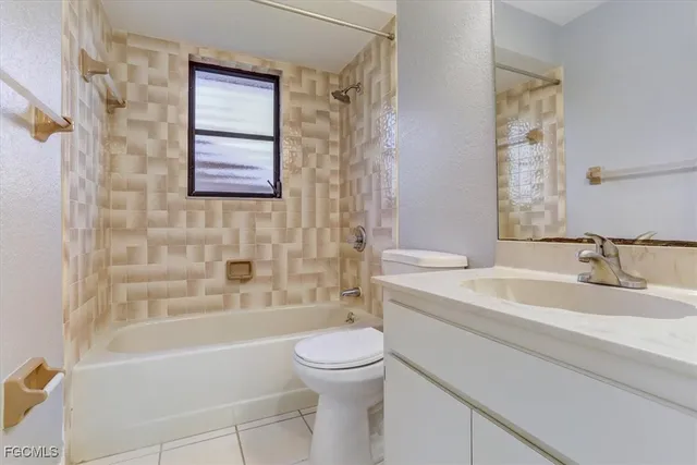 a bathroom with a bathtub shower sink vanity mirror and toilet